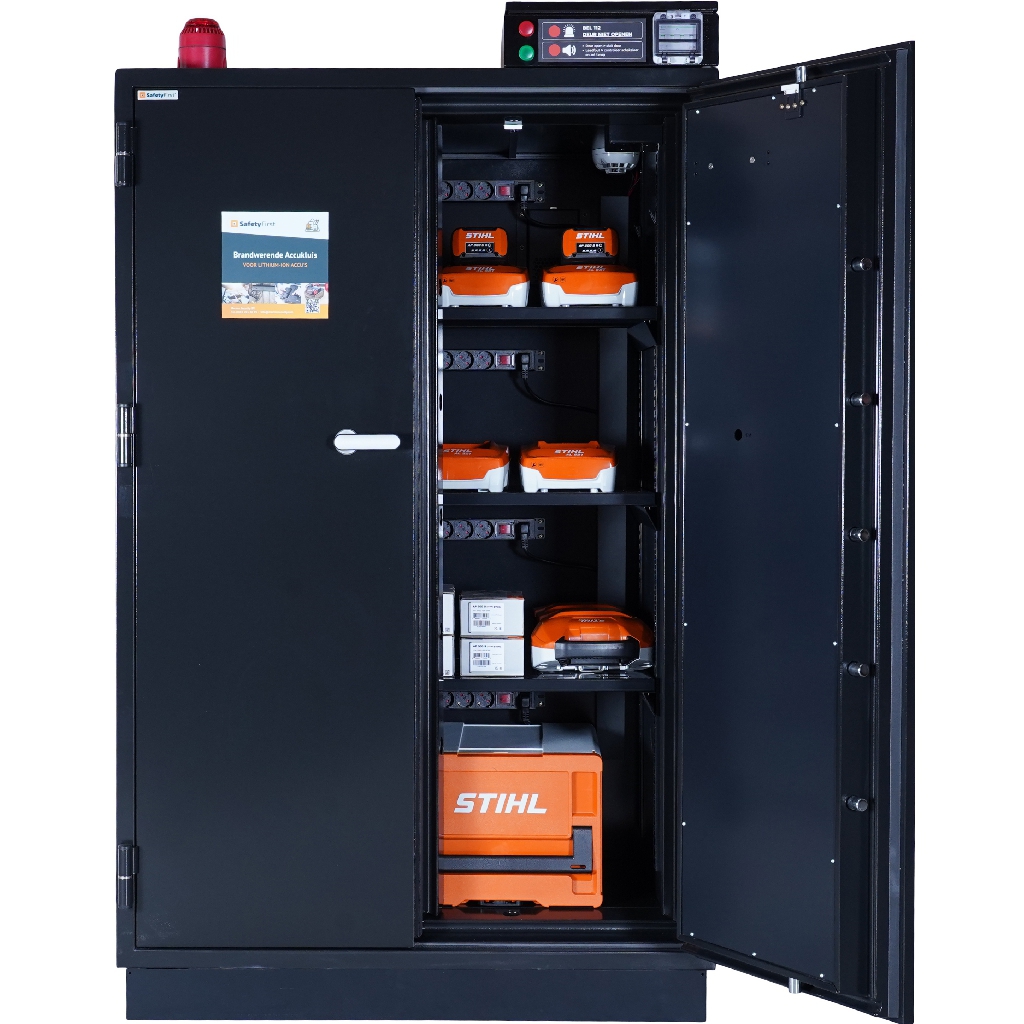 A SafetyFirst BS-4K charging cabinet with one door open, power tool batteries on charge across four shelves, each with its own socket strip, and a monitoring panel and alarm beacon on top